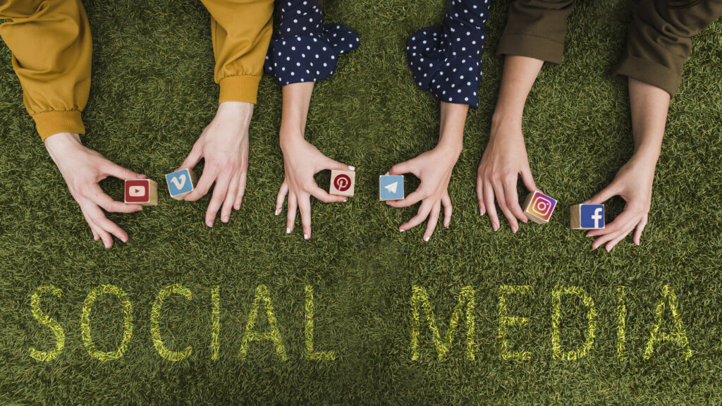 Overhead-view-female-holding-social-network-app-symbol-blocks-lawn-scaled